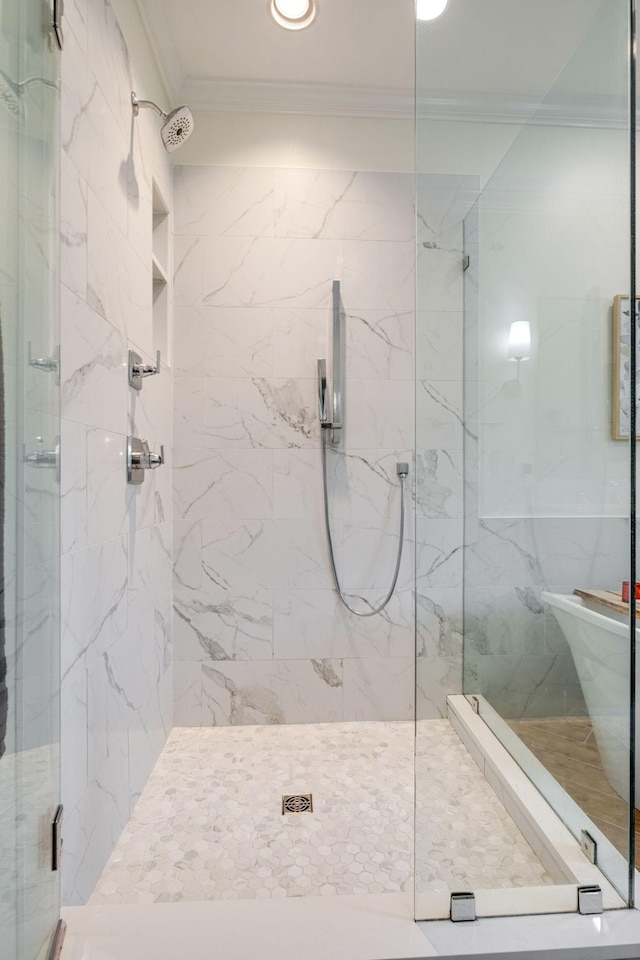 full bathroom featuring ornamental molding and a marble finish shower