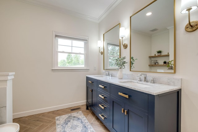 bathroom with crown molding, a sink, baseboards, and double vanity