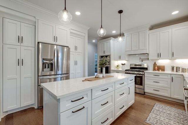 kitchen featuring white cabinets, stainless steel appliances, recessed lighting, decorative backsplash, and ornamental molding