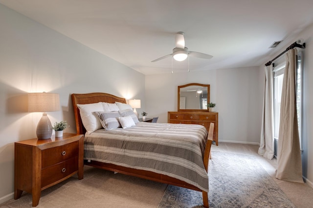 bedroom featuring a ceiling fan, baseboards, light colored carpet, and visible vents