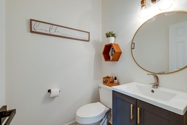 half bath featuring vanity and toilet