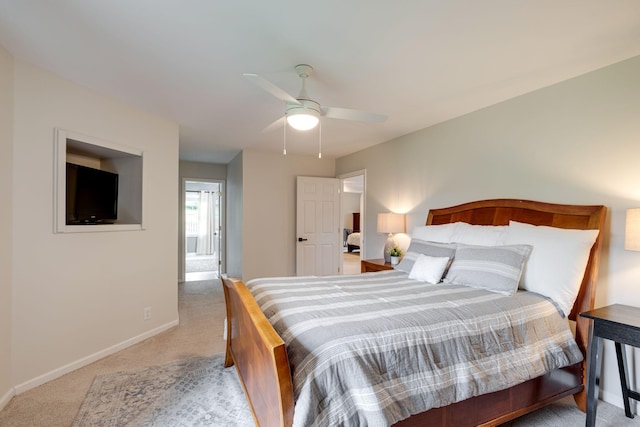 bedroom with baseboards, ceiling fan, and light carpet