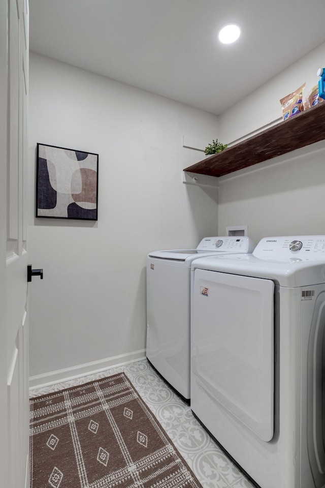 washroom featuring laundry area, washing machine and dryer, and baseboards
