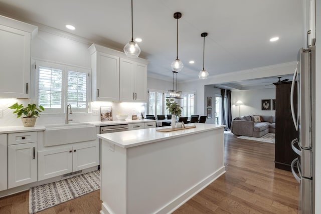 kitchen featuring crown molding, a sink, and tasteful backsplash