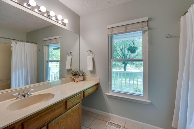 1233 Hardwood Trl, Burns, TN 37029 - full bathroom with visible vents, vanity, baseboards, a textured ceiling, and tile patterned floors