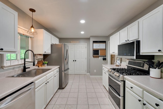 1233 Hardwood Trl, Burns, TN 37029 - kitchen featuring light tile patterned flooring, baseboards, white cabinetry, a sink, and stainless steel appliances