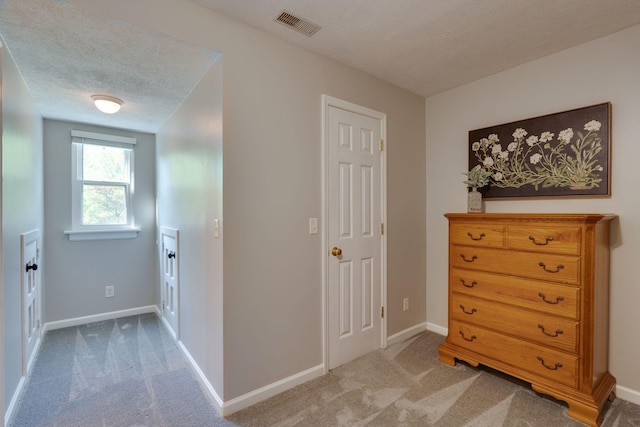 1233 Hardwood Trl, Burns, TN 37029 - corridor featuring baseboards, carpet flooring, a textured ceiling, and visible vents