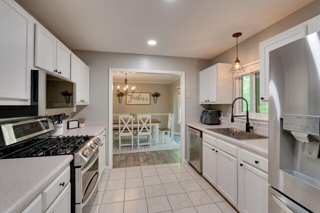 1233 Hardwood Trl, Burns, TN 37029 - kitchen with light countertops, a sink, white cabinets, and stainless steel appliances