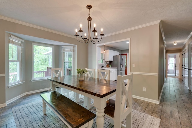 1233 Hardwood Trl, Burns, TN 37029 - dining room featuring a chandelier, ornamental molding, a healthy amount of sunlight, and wood finished floors