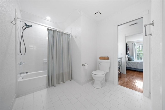 ensuite bathroom with visible vents, crown molding, toilet, baseboards, and tile patterned floors