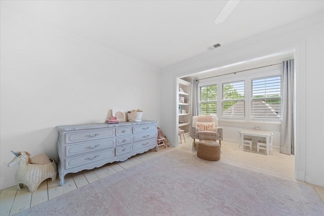 living area with visible vents and crown molding
