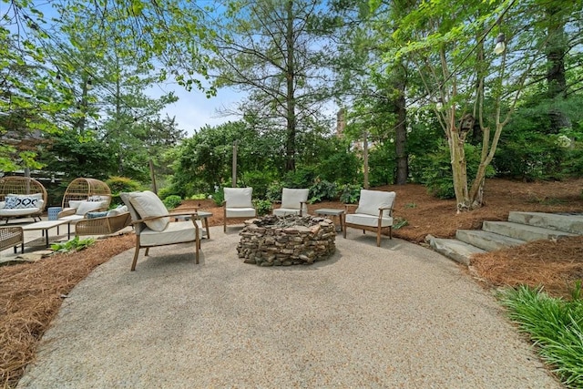 view of patio featuring an outdoor living space with a fire pit
