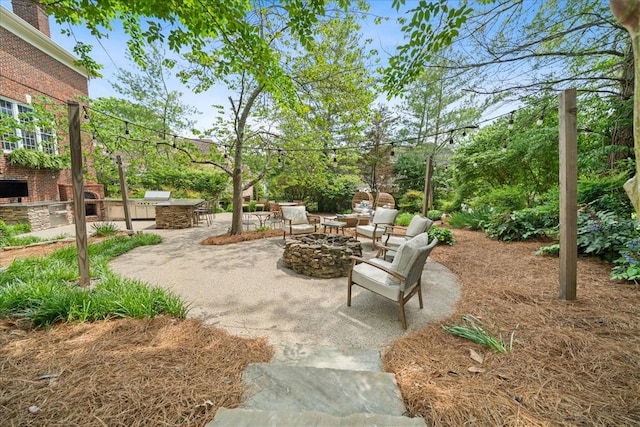 view of patio / terrace with an outdoor fire pit