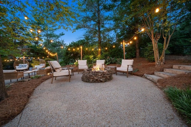 view of patio with an outdoor living space with a fire pit