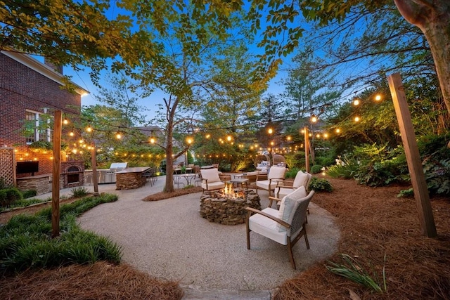 view of patio with a fire pit and exterior kitchen