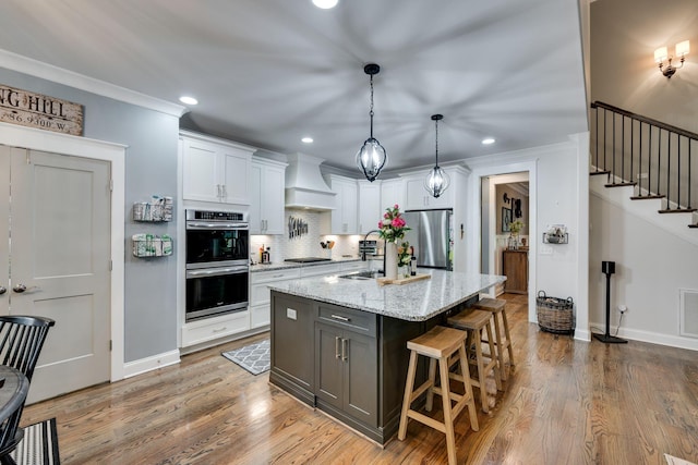 2965 Stewart Campbell Pt, Spring Hill, TN 37174 - kitchen with stainless steel appliances, recessed lighting, white cabinetry, decorative backsplash, and custom range hood