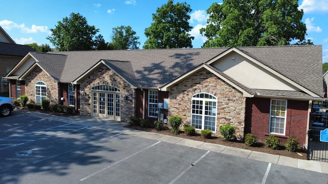 2965 Stewart Campbell Pt, Spring Hill, TN 37174 - view of front of house with uncovered parking, roof with shingles, french doors, and stone siding