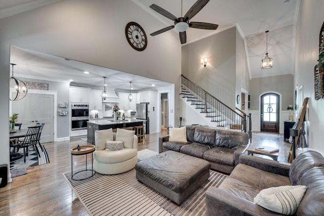 2965 Stewart Campbell Pt, Spring Hill, TN 37174 - living area featuring a ceiling fan, high vaulted ceiling, light wood finished floors, ornamental molding, and stairs