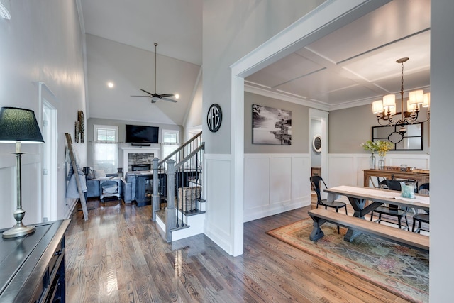 2965 Stewart Campbell Pt, Spring Hill, TN 37174 - dining area with wood finished floors, a stone fireplace, stairway, a wainscoted wall, and ceiling fan with notable chandelier