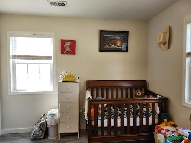 207 Merideth Ave, Waverly, TN 37185 - bedroom featuring visible vents, baseboards, wood finished floors, and multiple windows