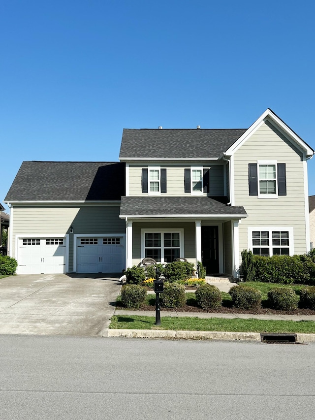 traditional-style home featuring an attached garage and driveway