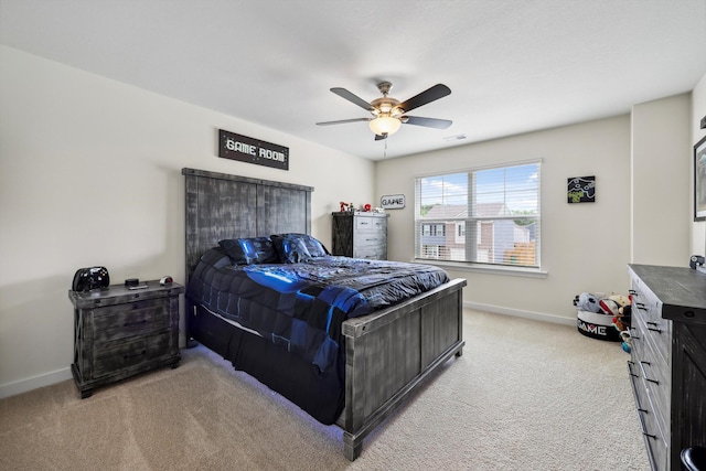 bedroom with baseboards, visible vents, a ceiling fan, and light colored carpet