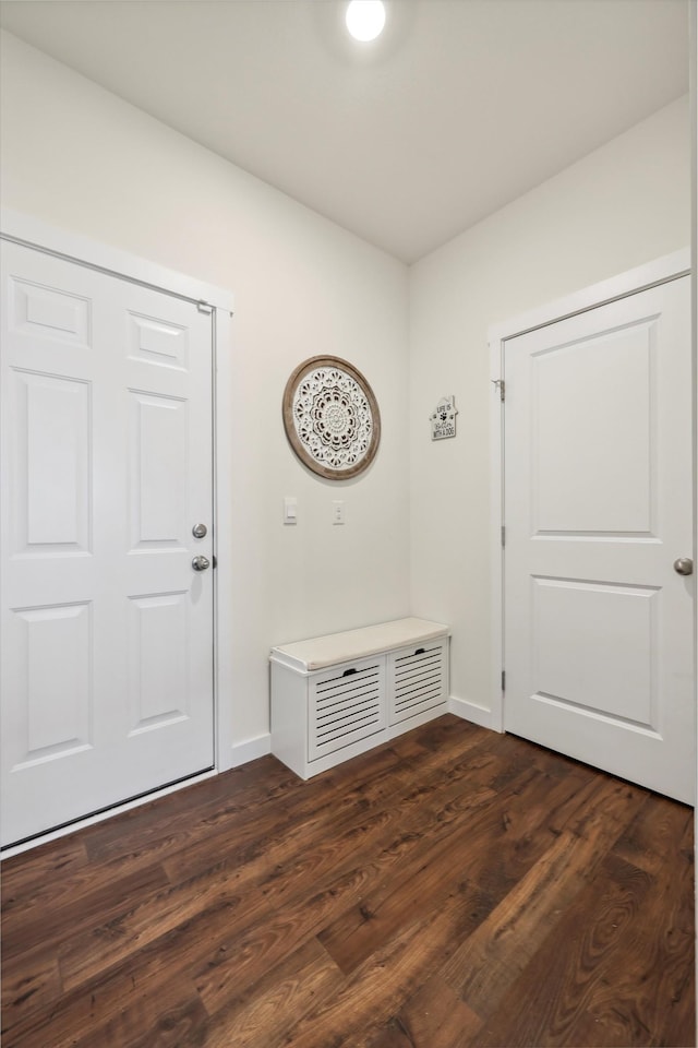 mudroom featuring baseboards, vaulted ceiling, and dark wood-style flooring