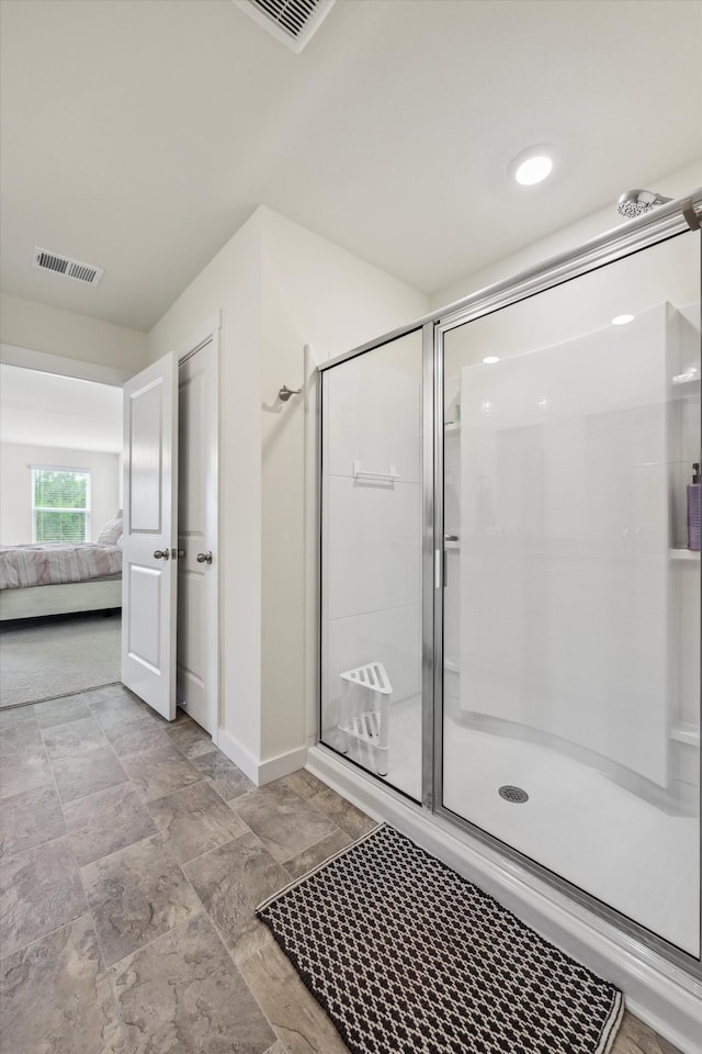 ensuite bathroom with baseboards, a stall shower, ensuite bath, and visible vents