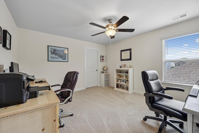 office featuring ceiling fan, visible vents, baseboards, and carpet