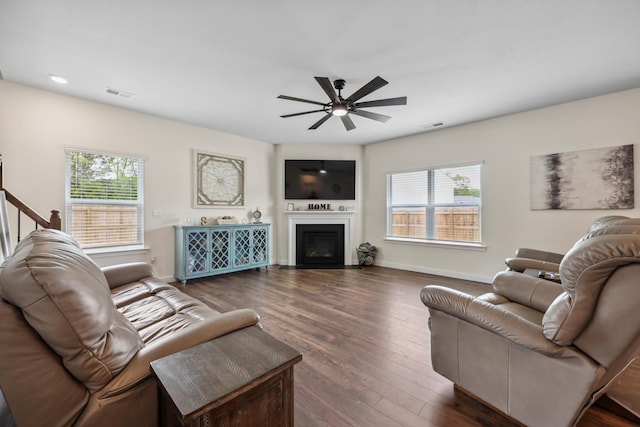 living room with visible vents, a ceiling fan, and a healthy amount of sunlight