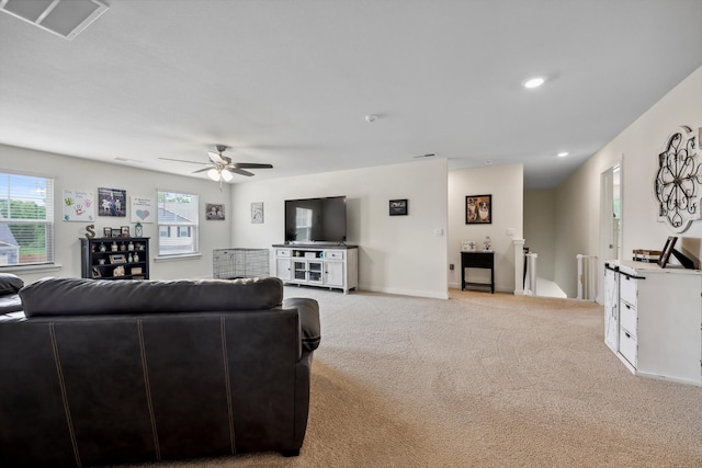 living room with a ceiling fan, visible vents, baseboards, light carpet, and recessed lighting