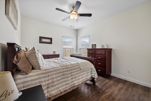 bedroom featuring dark wood-style flooring, baseboards, and ceiling fan