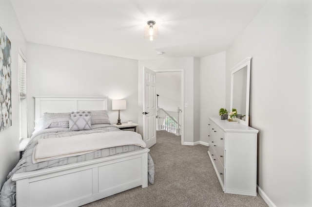bedroom featuring baseboards and light carpet