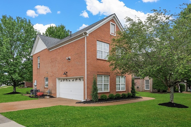 view of side of property featuring brick siding, a garage, a yard, and concrete driveway