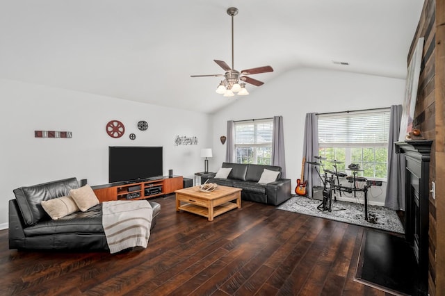 living area with wood finished floors, ceiling fan, lofted ceiling, and a healthy amount of sunlight