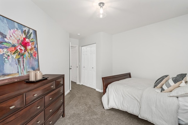 bedroom with baseboards, a closet, and light colored carpet