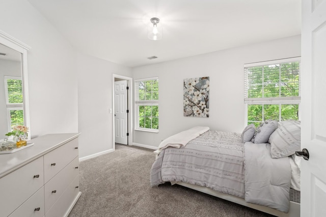 carpeted bedroom with baseboards and visible vents