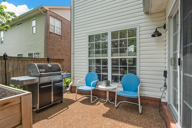 view of patio featuring area for grilling and fence