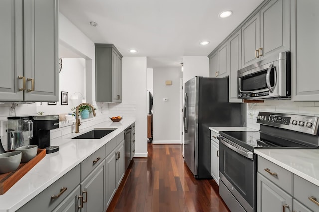 kitchen featuring a sink, gray cabinets, and stainless steel appliances