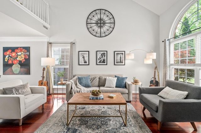 living room with crown molding, high vaulted ceiling, visible vents, and dark wood-type flooring
