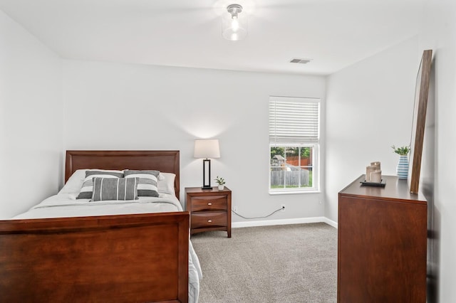 carpeted bedroom with baseboards and visible vents