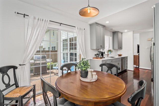 dining space with recessed lighting, baseboards, and dark wood-style floors
