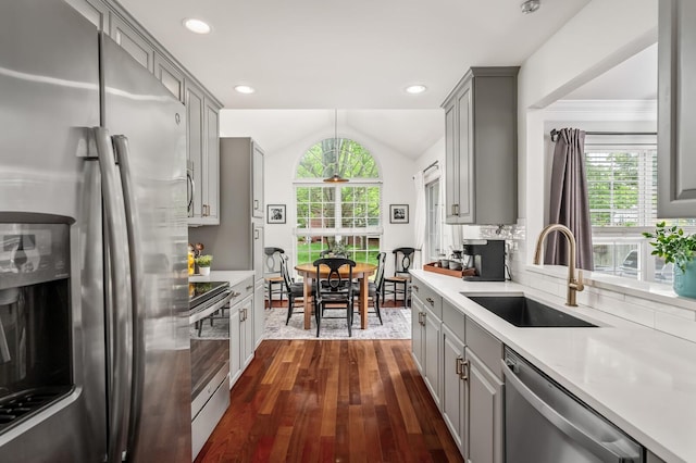kitchen featuring light countertops, gray cabinetry, appliances with stainless steel finishes, and a sink