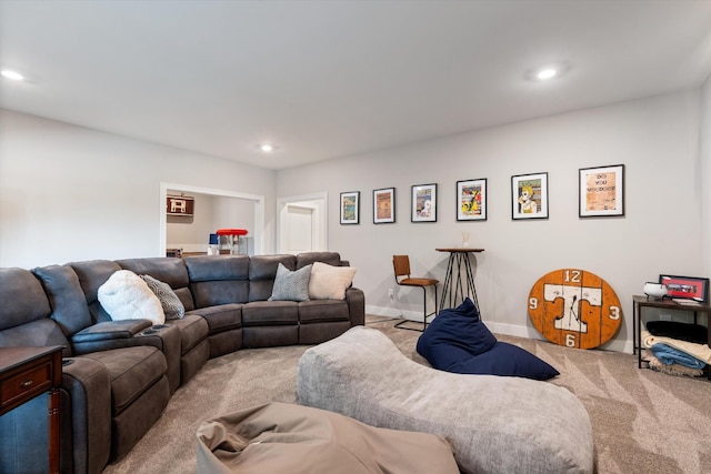 carpeted living area with recessed lighting and baseboards
