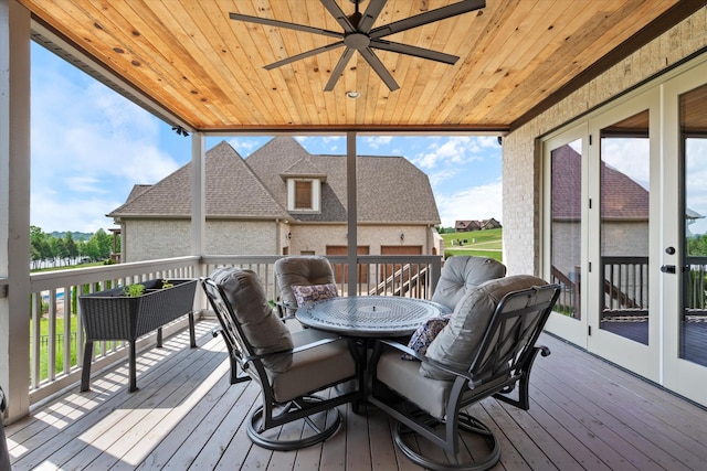 wooden terrace featuring a ceiling fan and outdoor dining space