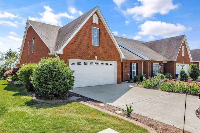 traditional home featuring brick siding, a front lawn, concrete driveway, an attached garage, and a shingled roof
