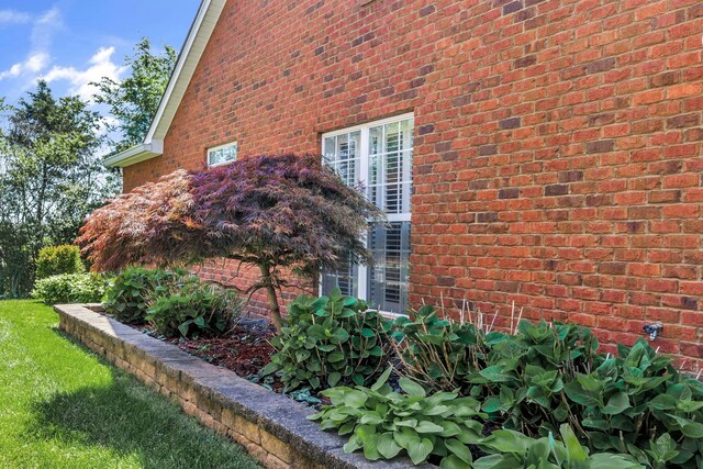 view of property exterior with brick siding