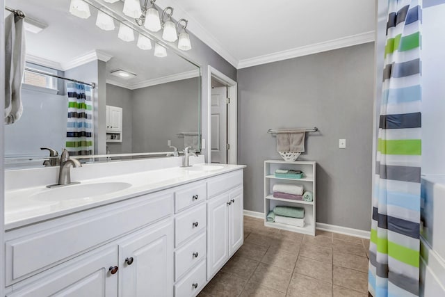 full bath with a sink, baseboards, crown molding, and double vanity