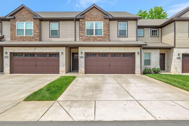 view of property with an attached garage, a shingled roof, stone siding, and concrete driveway