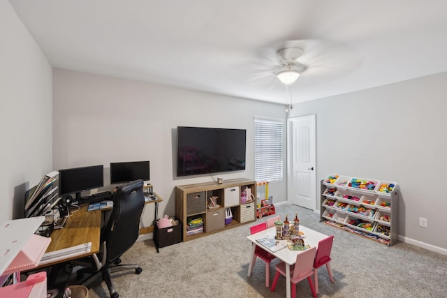 carpeted office featuring baseboards and ceiling fan